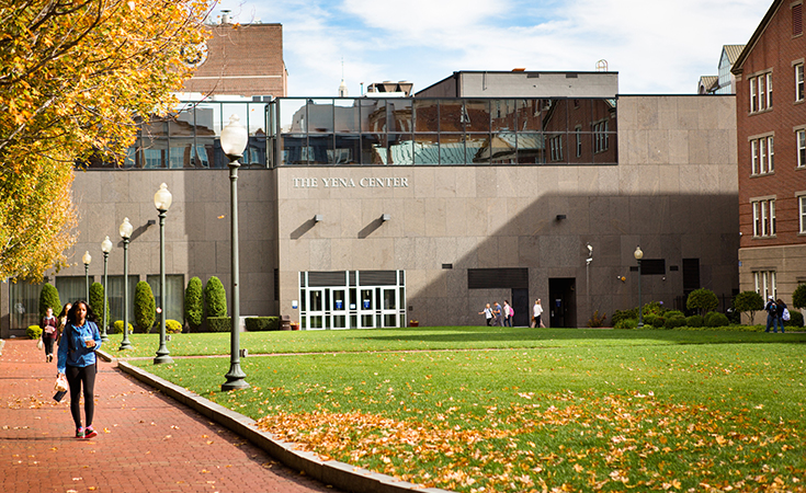 Student walking on Gaebe Commons in the Fall.