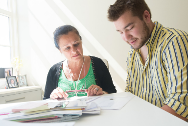 Applying for financial aid - Male student being guided through the Financial aid process by female financial advisor