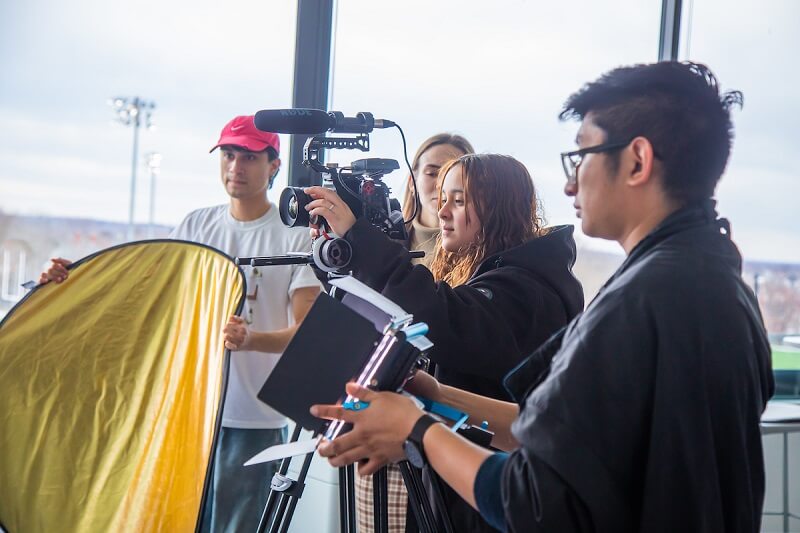 students filming together