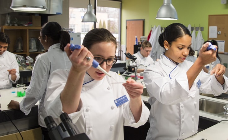 students using syringes in food science lab 