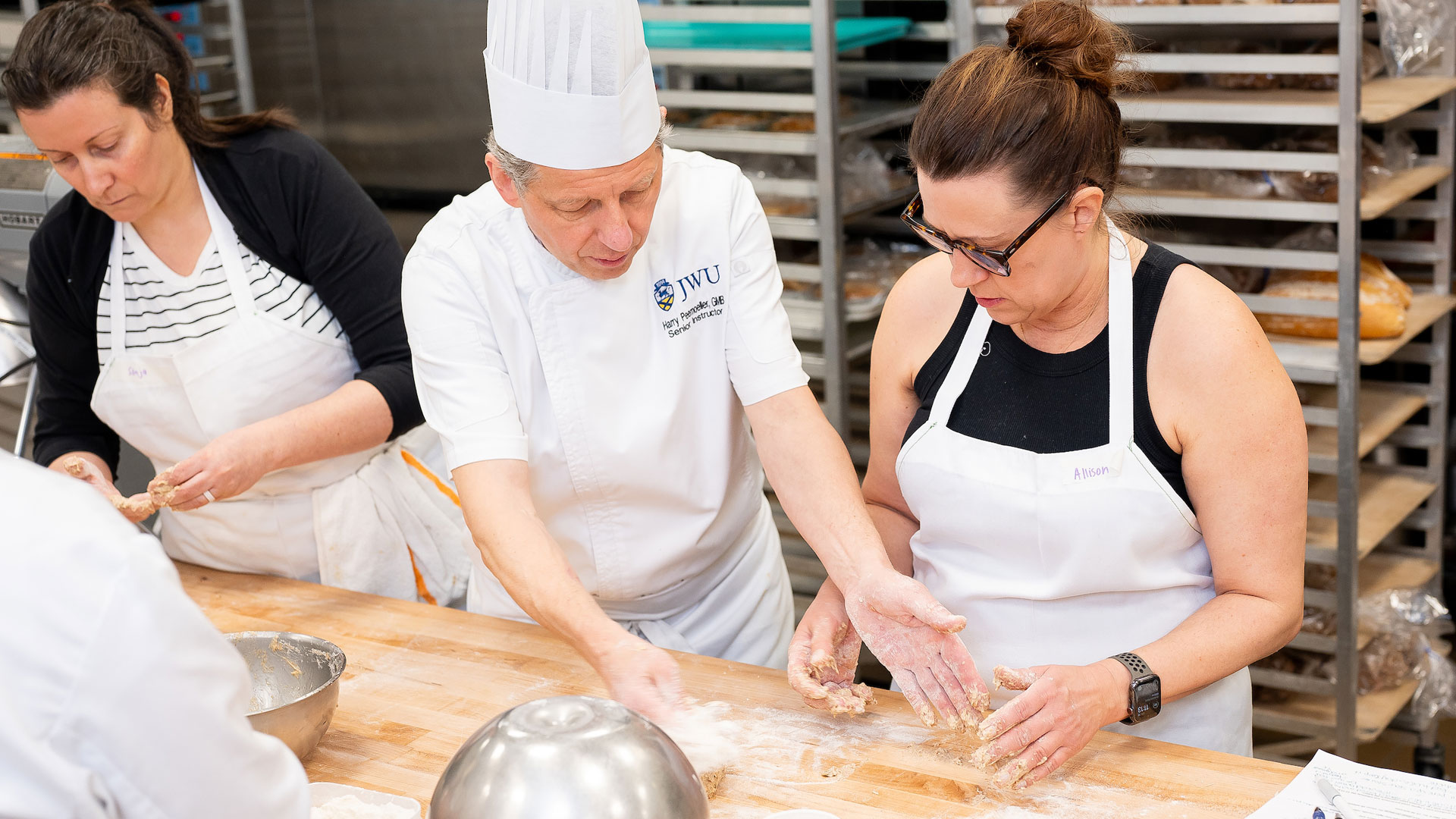 Professor Harry Peemoeller (center) teaches bread making during a cooking class.
