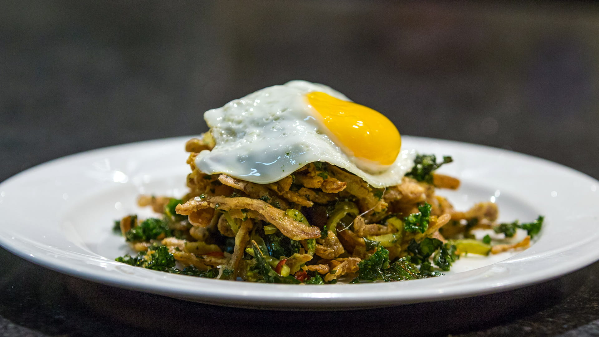 Final dish pigs ears and crispy kale.