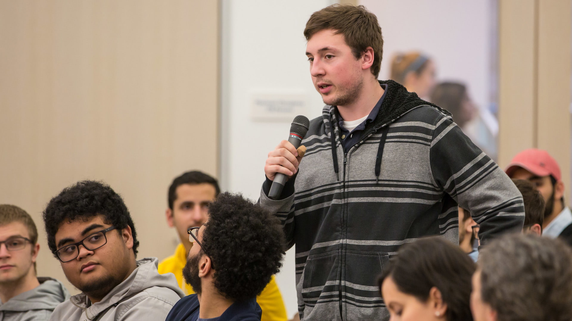 Student asking panel members a question.