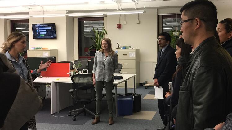 Upserve staff Courtney Nardozza, senior talent business partner and JWU alumna Nicole Theohary'15, manager, customer service  give JWU MBA students a tour of Upserve.