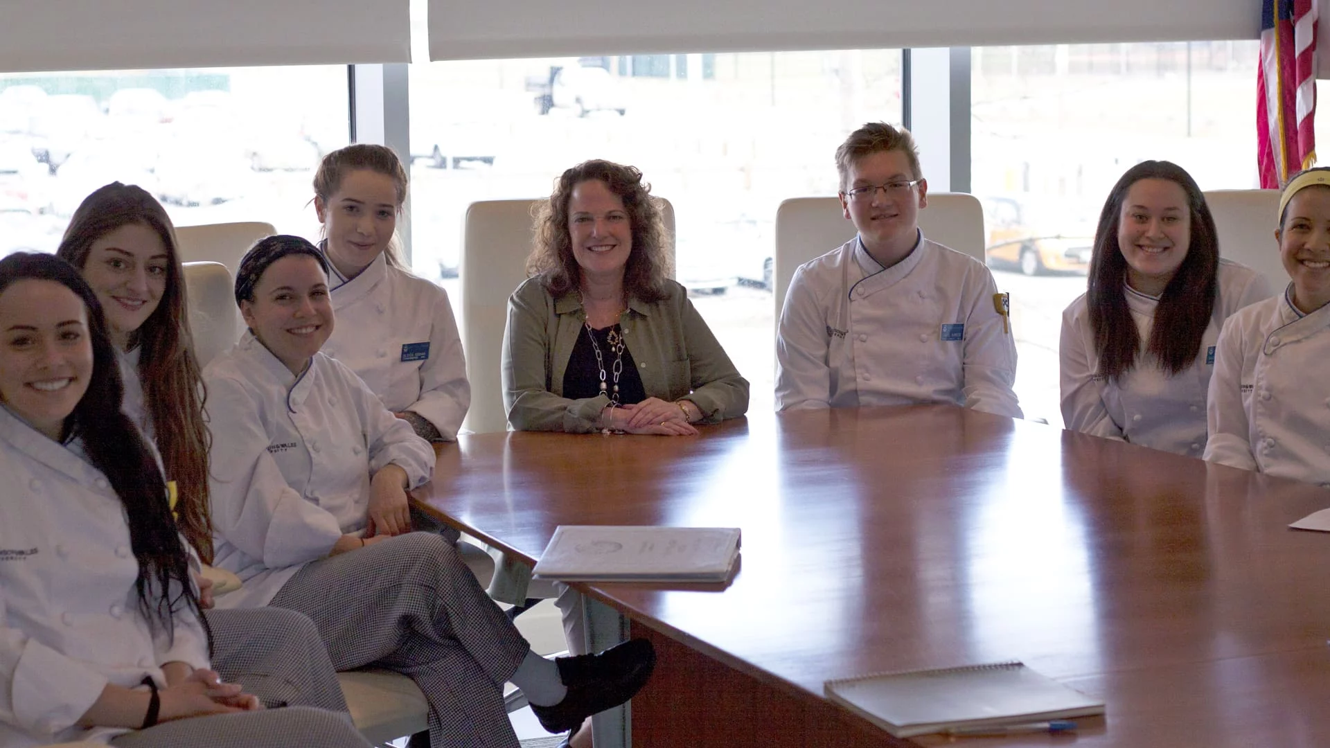 Vitamix CEO Jodi Berg posing with students at a table.