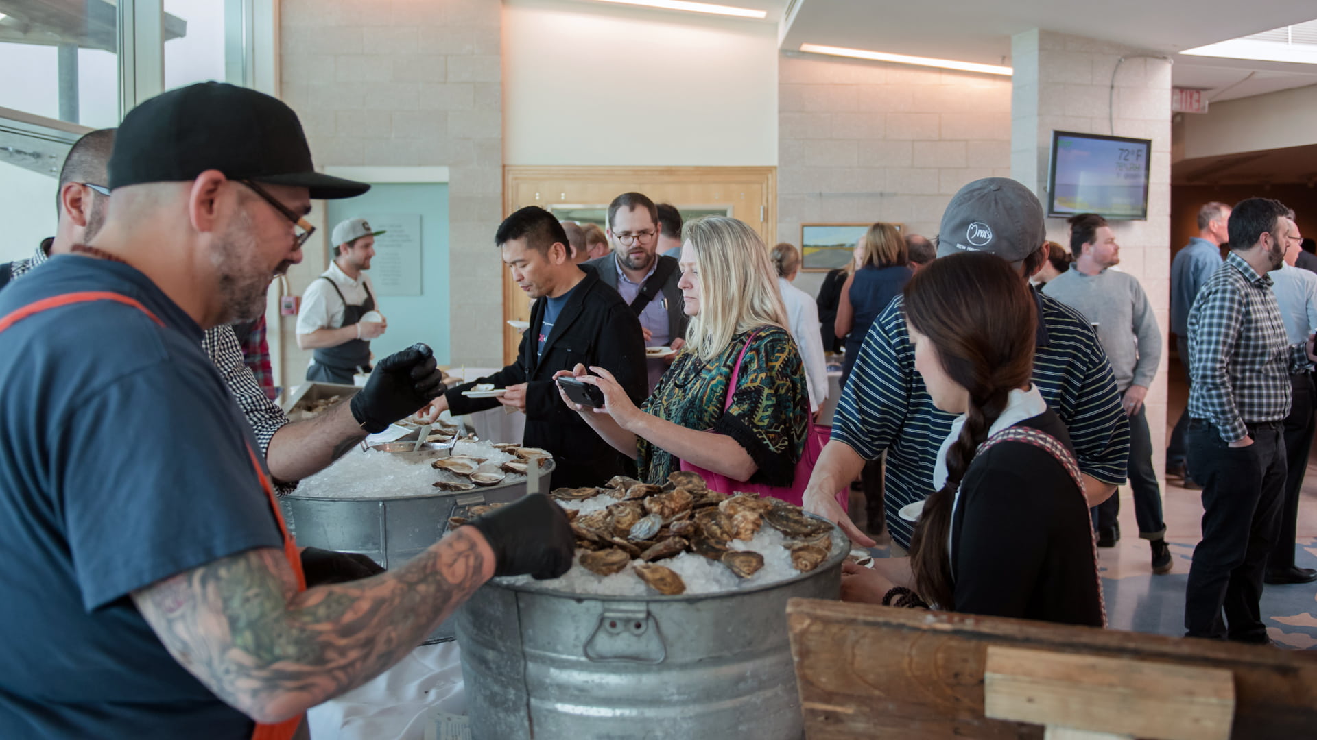 Trying oysters at the post-Symposium mixer.