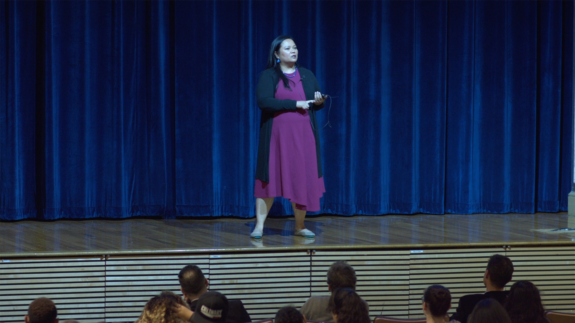 Grace Talusan on stage talking to JWU students and faculty