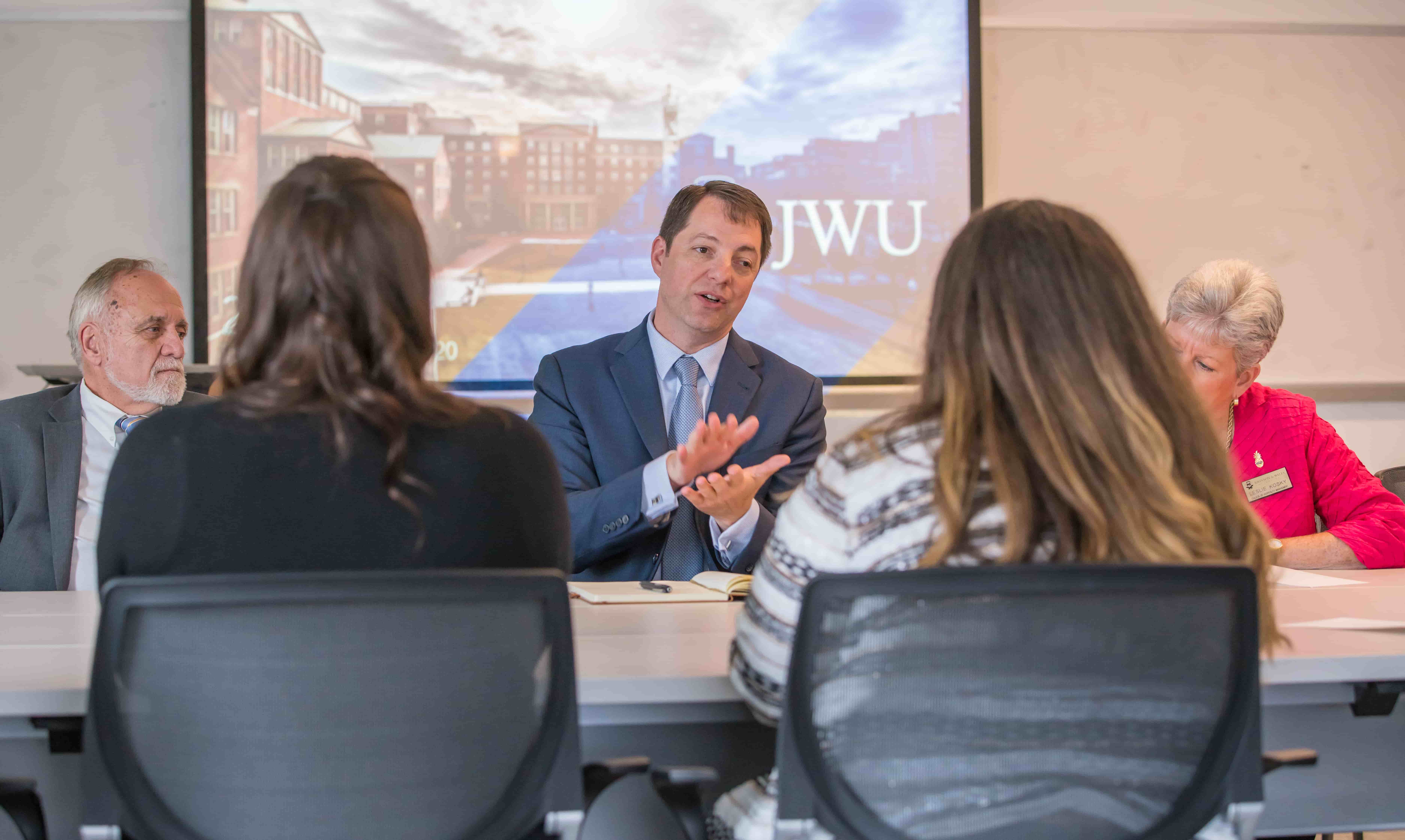 Jonathan Wilson speaking to Assistant Dean Robert Fink and JWU students.