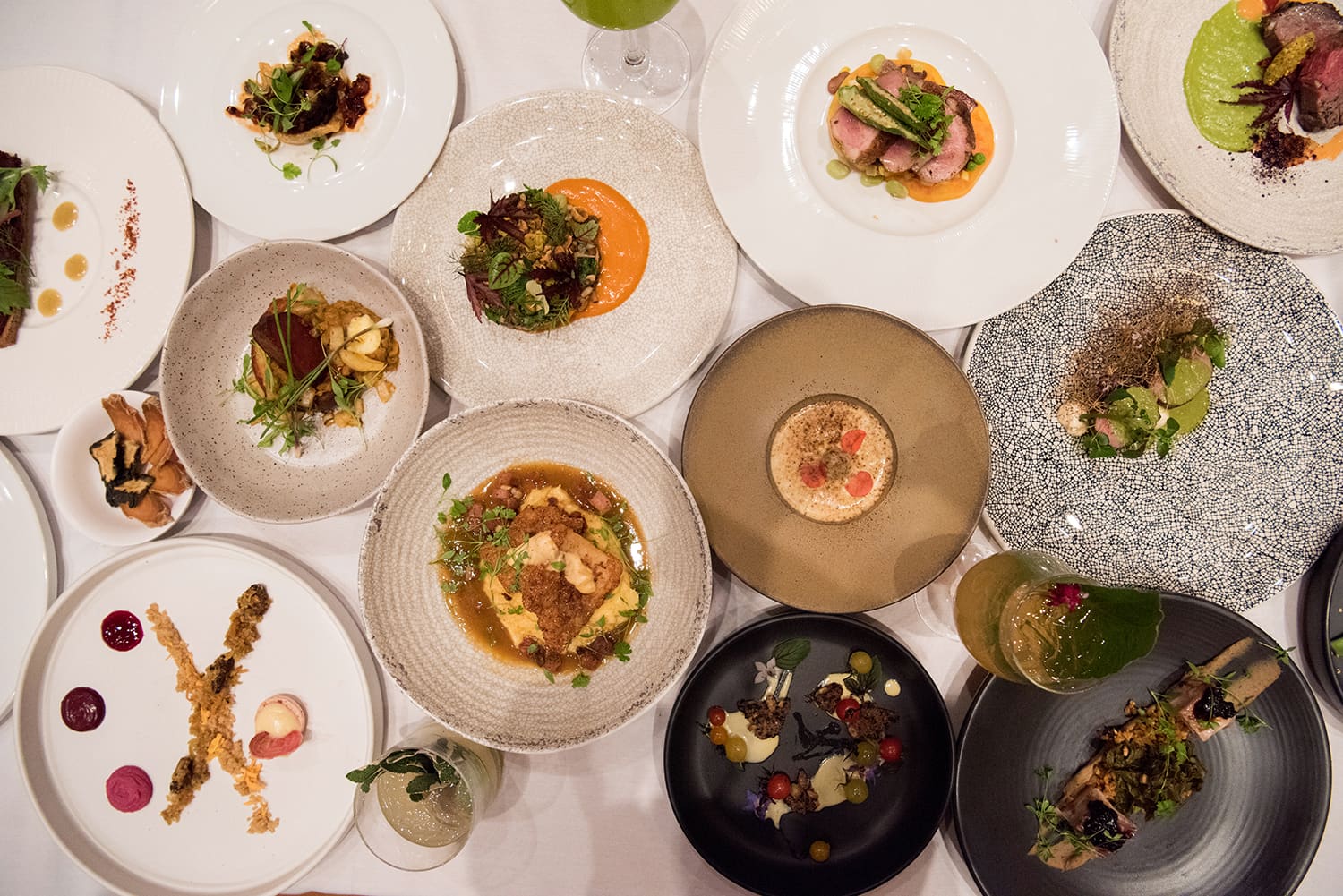 Plated dishes and bowls of fresh vegetables