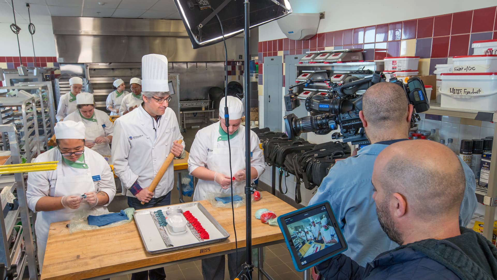 JWU Providence students filming a Super Bowl segment with CBS correspondent Mo Rocca