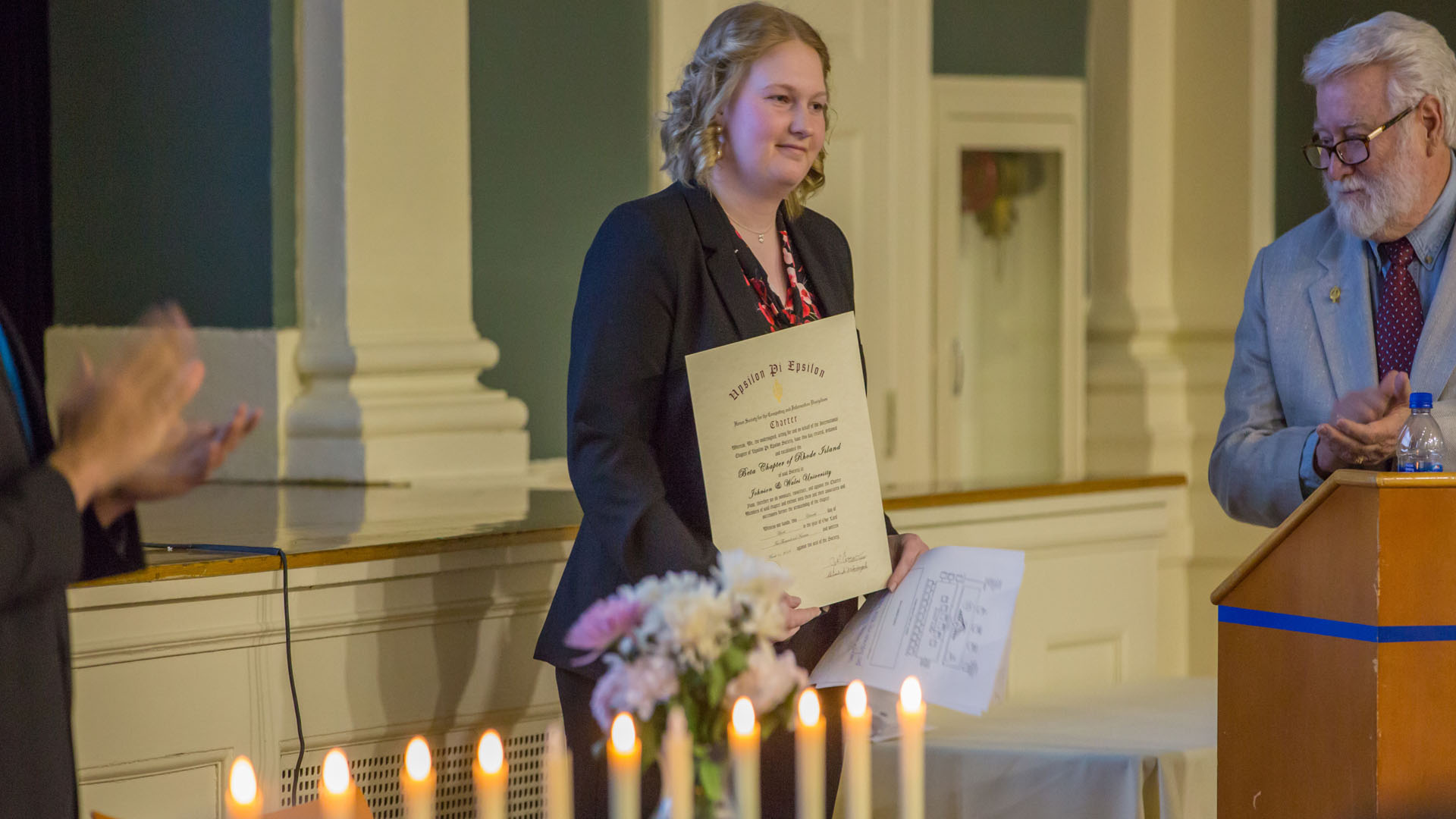 Alyson Calabrese, JWU UPE president, proudly shows off the charter declaration.