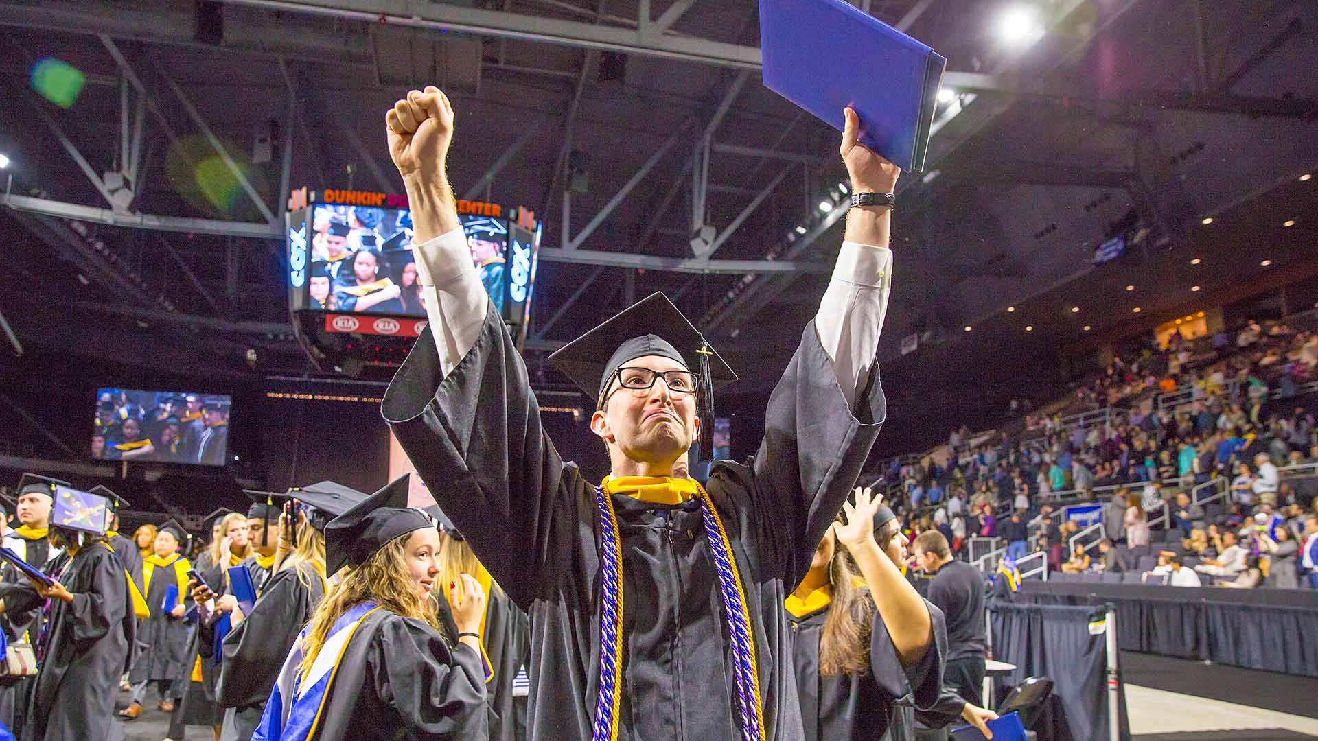 A graduate celebrating.