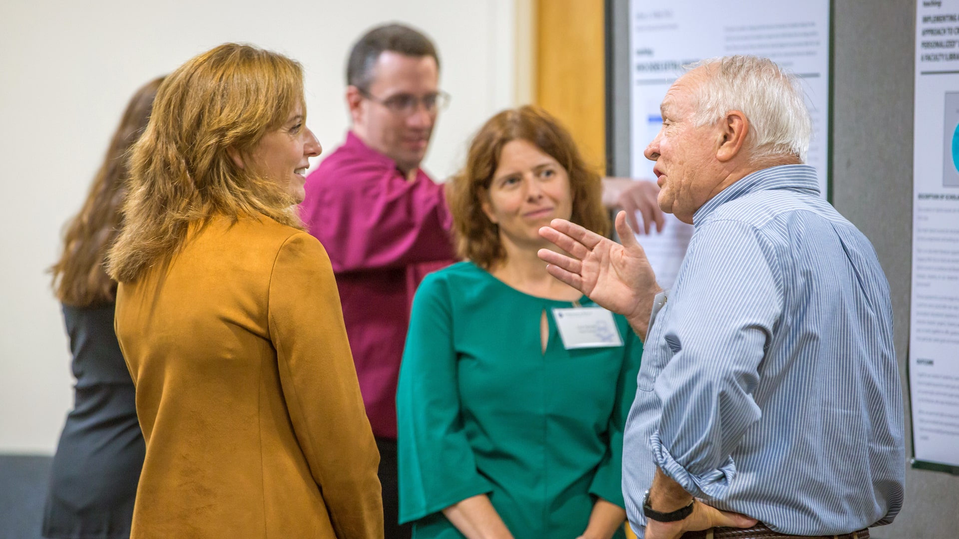 President Bernardo-Sousa chats with faculty.