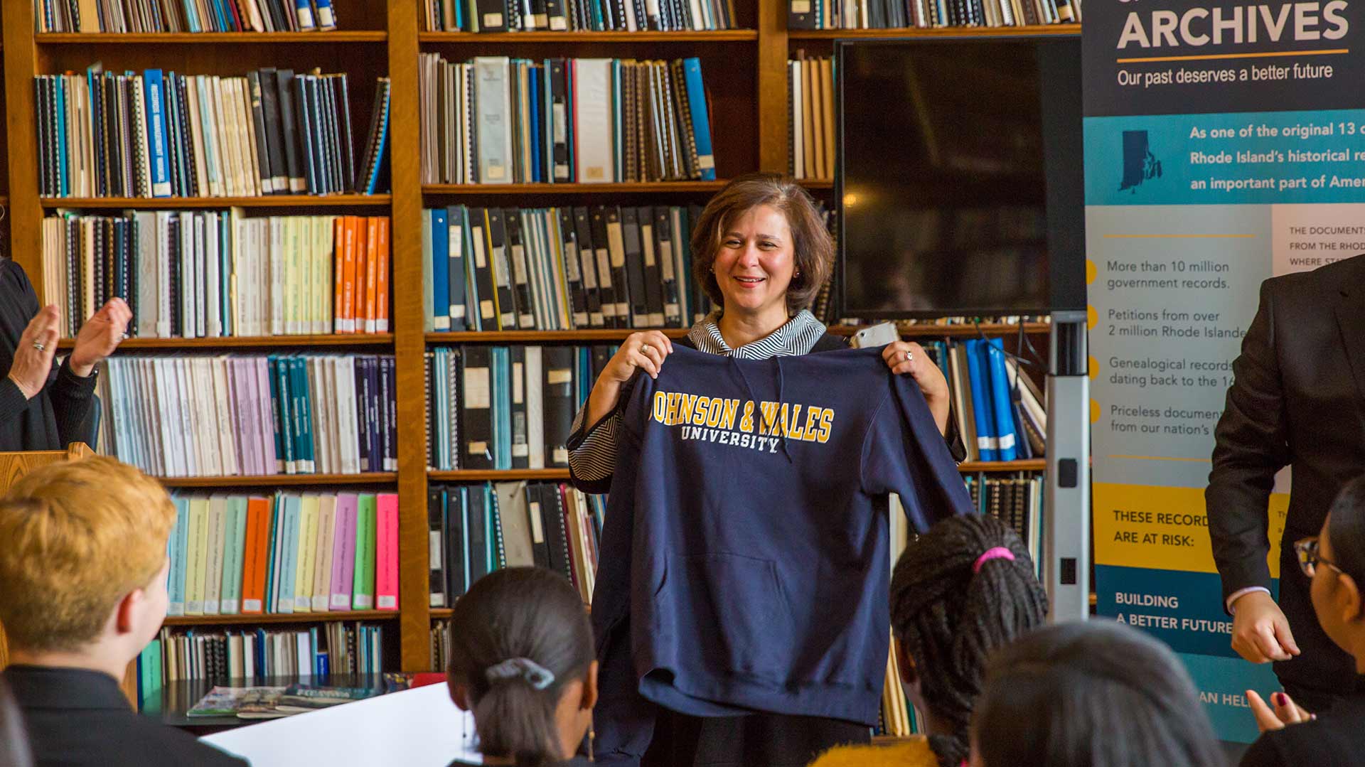 Secretary Gorbea receives a JWU sweatshirt