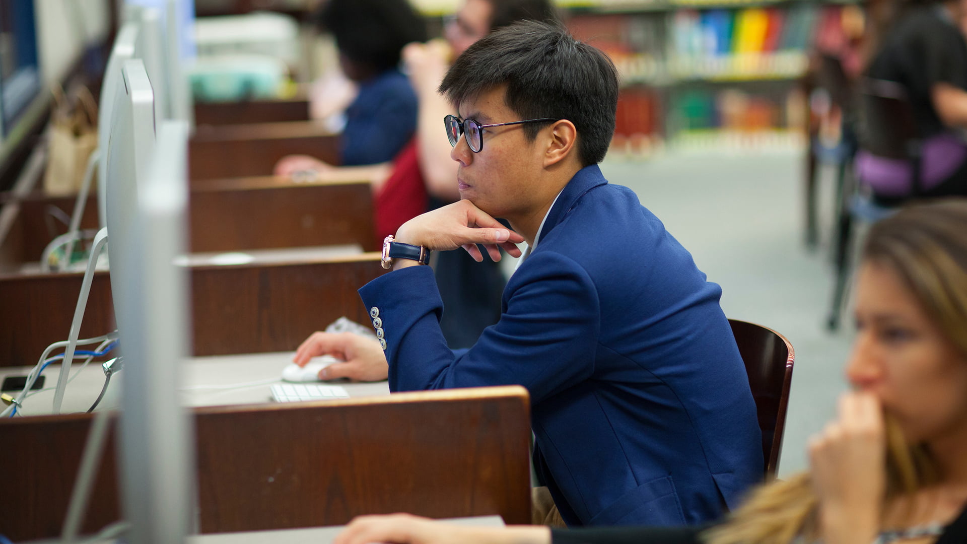 A student studying on a computer in the library