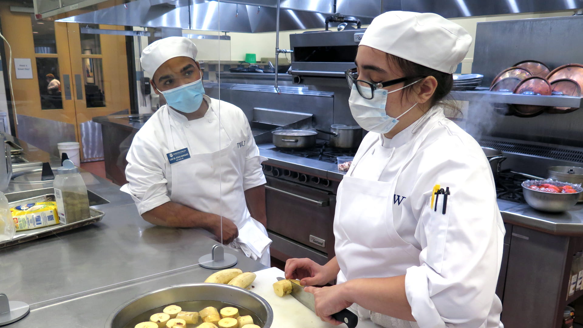 Transfer student Luis de Jesus Marquez '23 in the kitchen at the Charlotte Campus