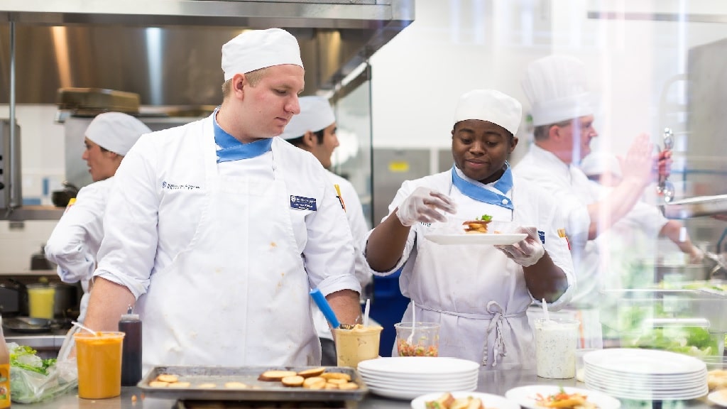 culinary students plating a dish