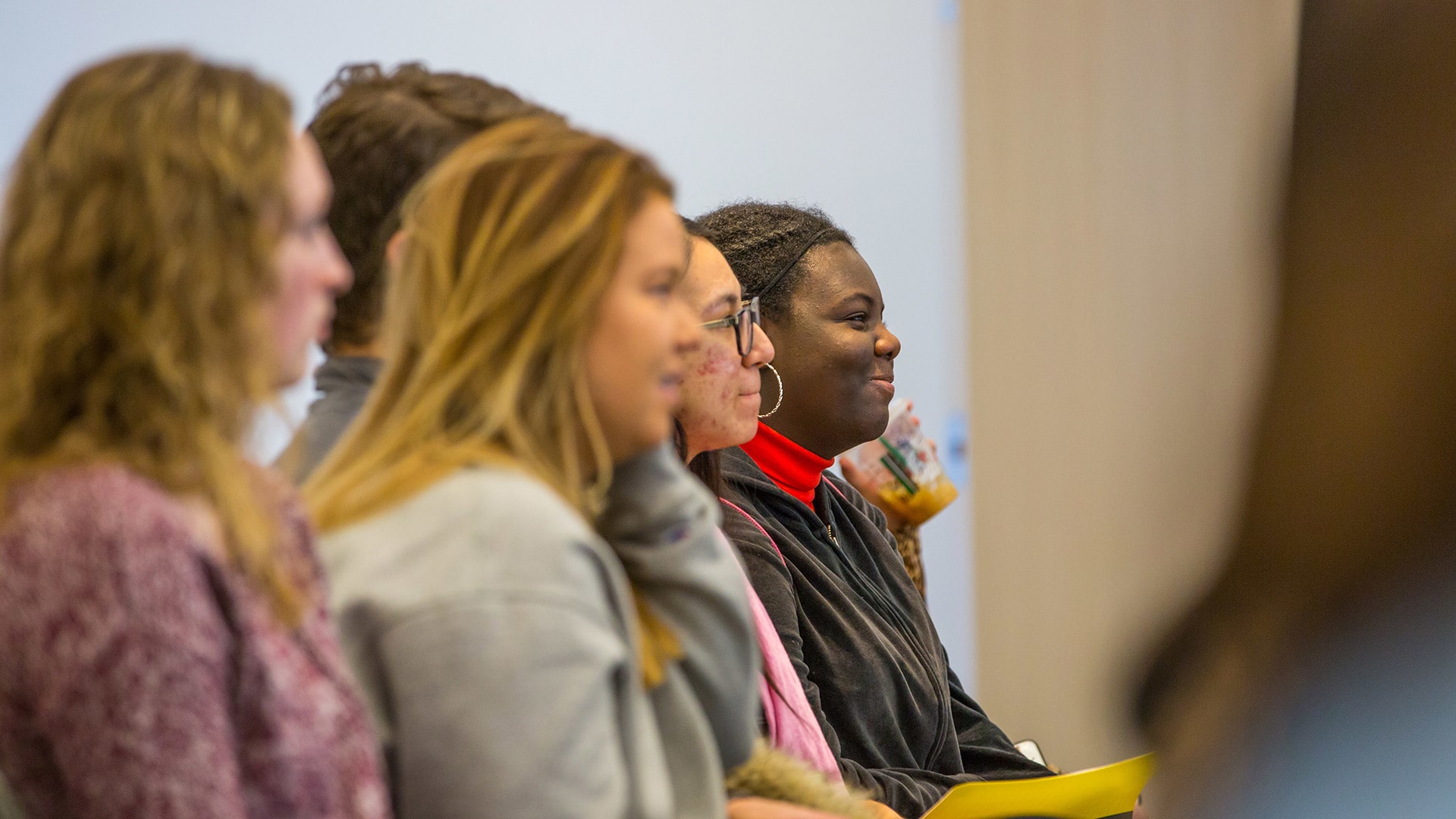 image of a row of prospective students enjoying checking out a classroom