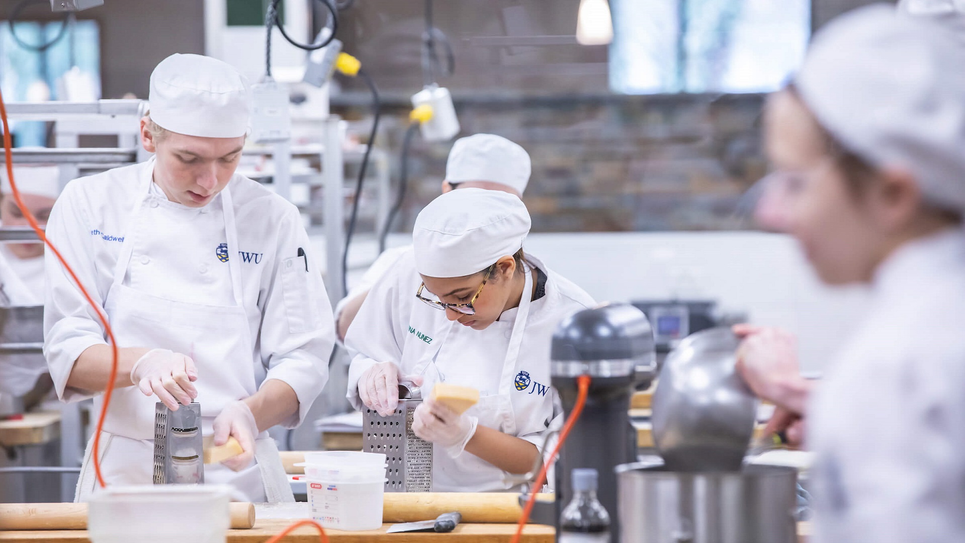 culinary students shredding cheese