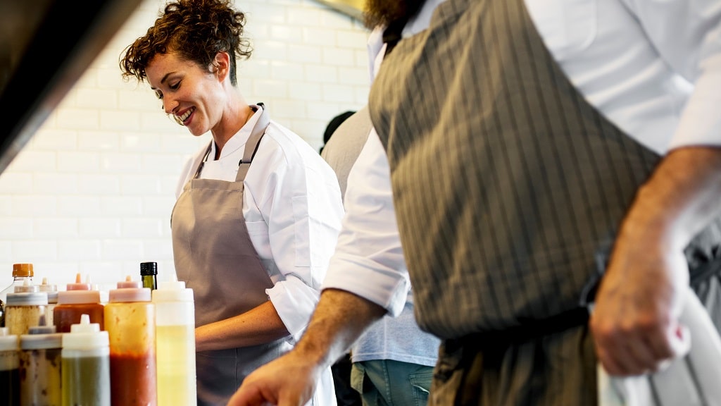 Female chef smiles in kitchen