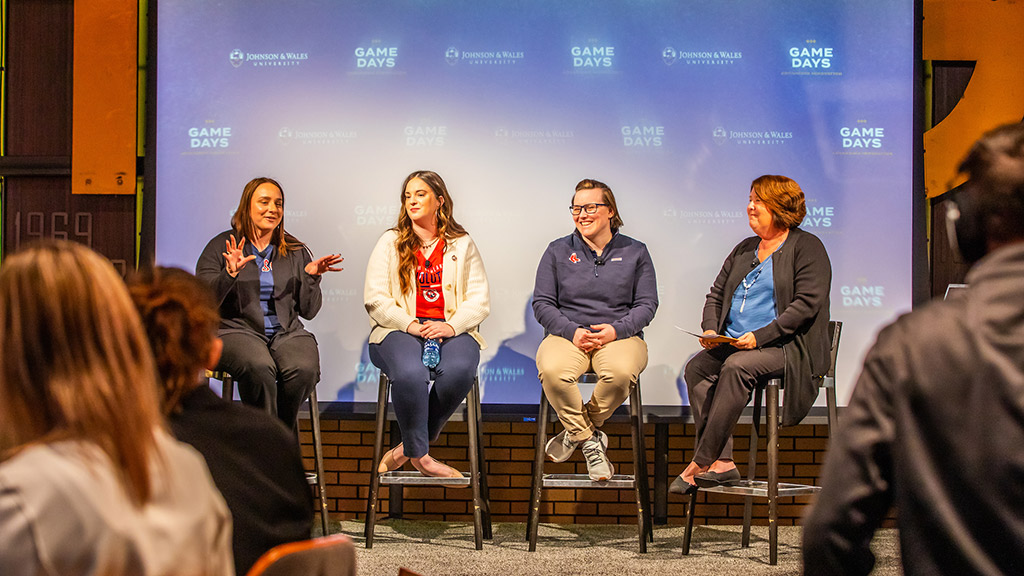 A panel of JWU alumni on stage at TD Garden Game Days seminar