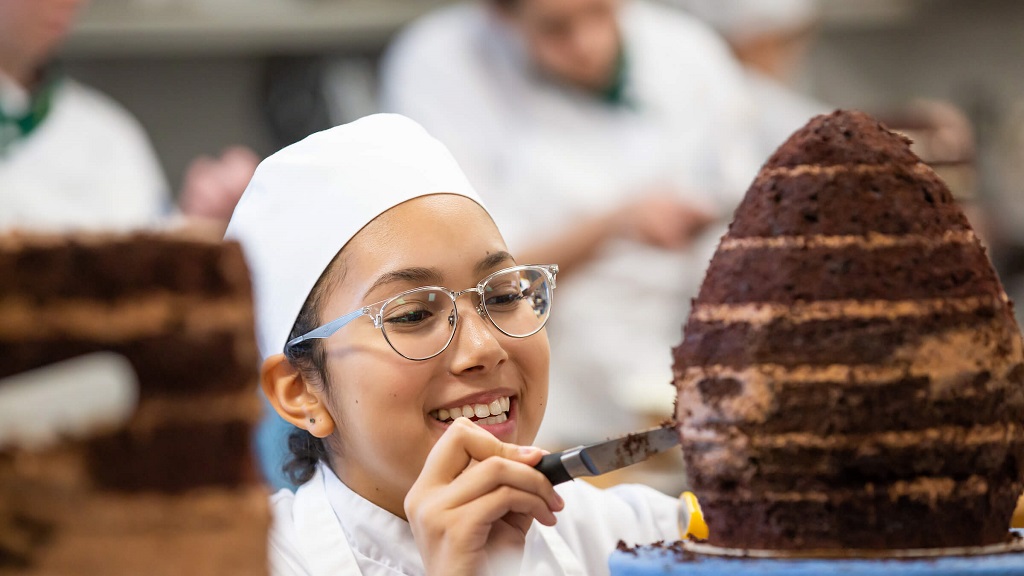 Culinary student making cake 