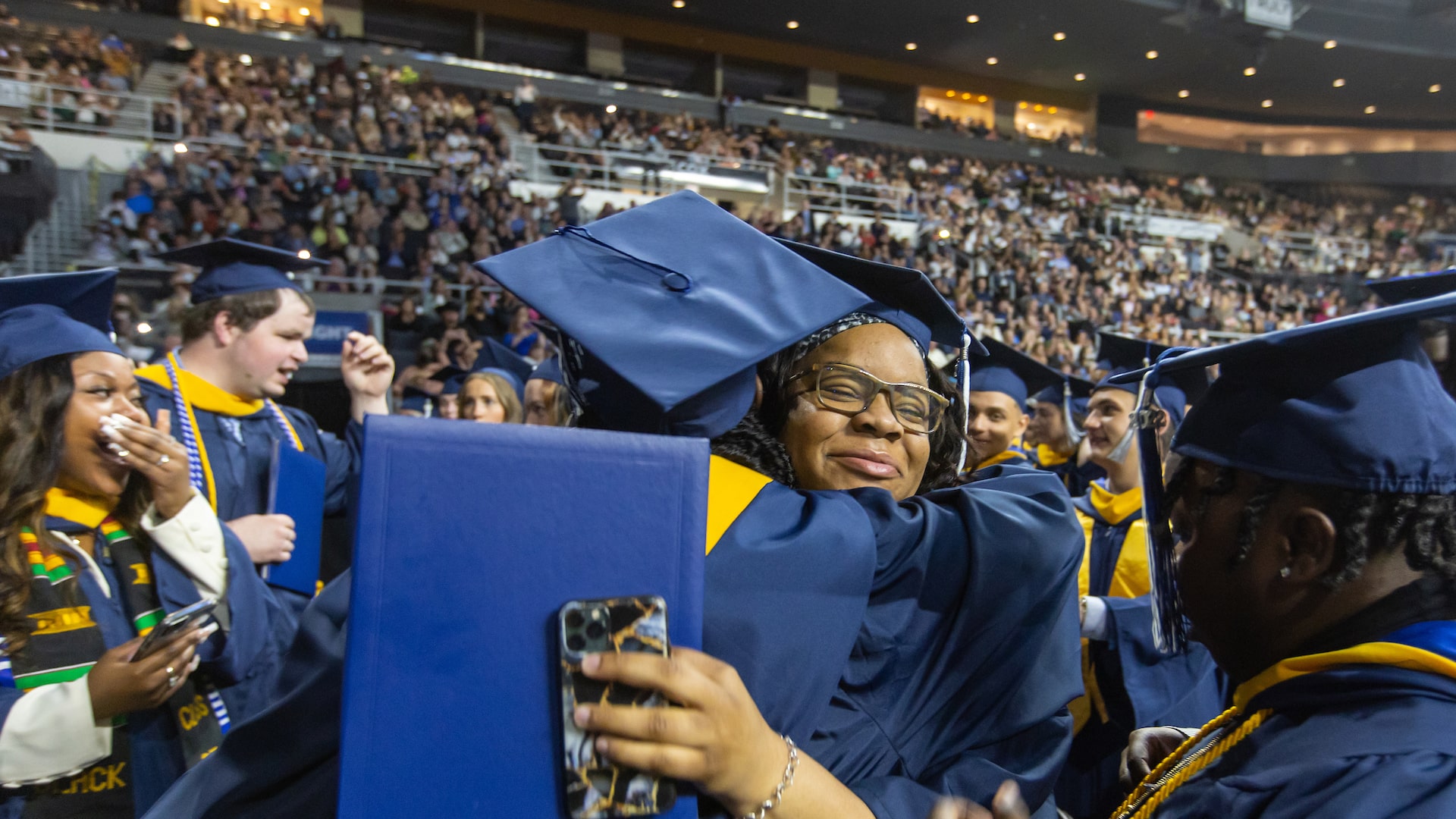 A big hug between two newly-minted graduates.