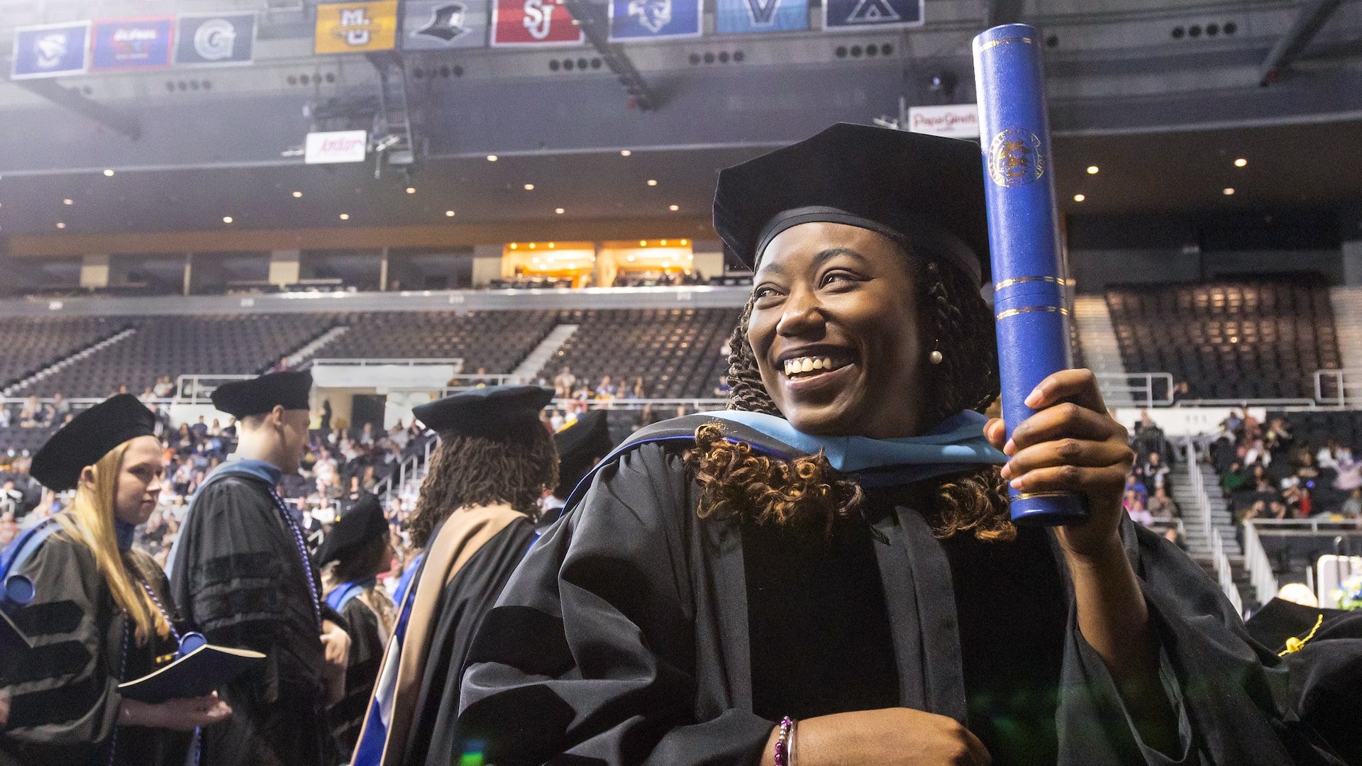 Happy grad at the 2022 Providence Graduate Studies Commencement.