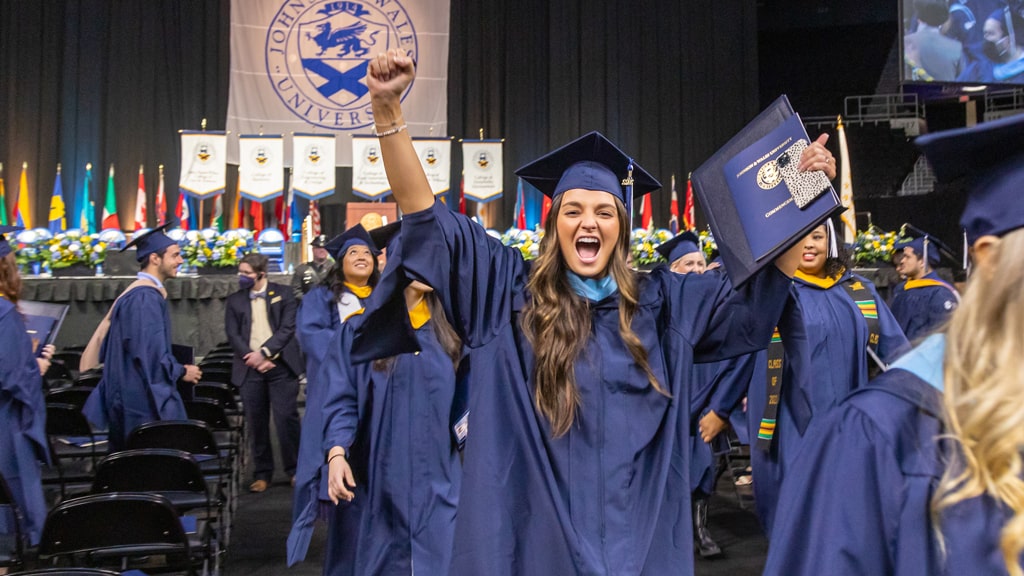 We did it! New graduates whooping with excitement near the Commencement stage.