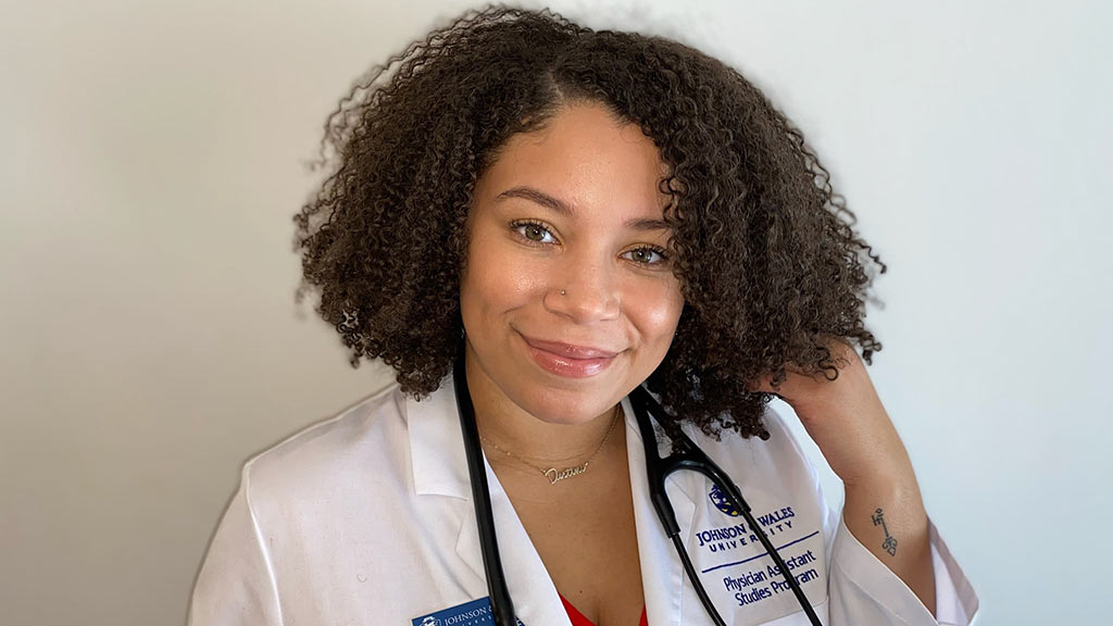 headshot of Destini Quinones wearing her JWU physician assistant white coat