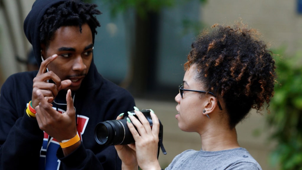 a boy and girl talking about a camera