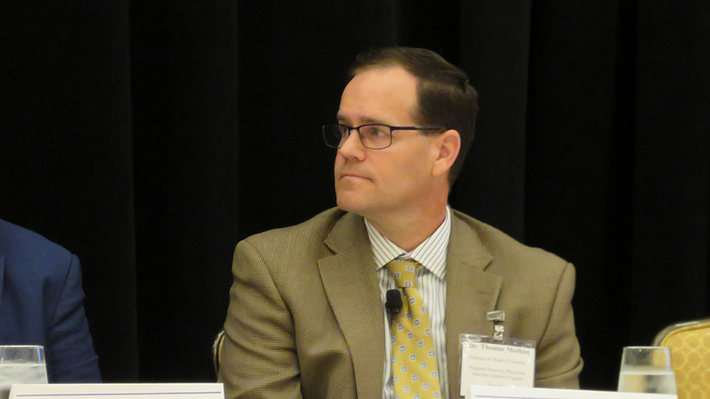 photo of Thomas Meehan at the panel table listening intently to the question being asked