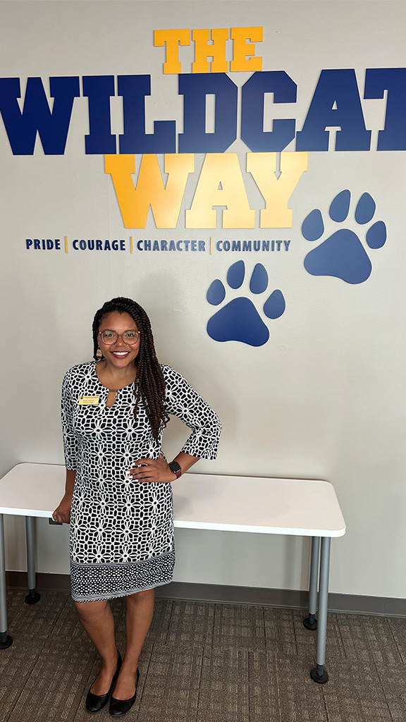 Nayira Warren in front of Wildcat Way sign