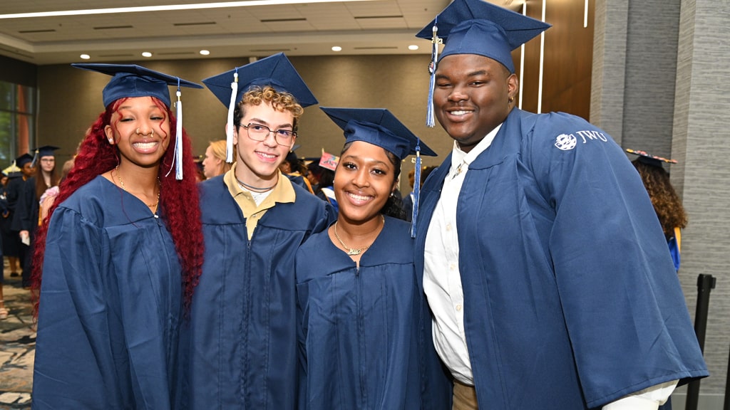 A quartet of happy graduates at Charlotte Commencement.