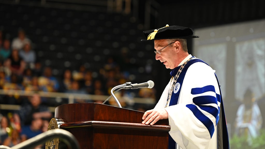 Charlotte Campus President Mathieu speaking to the Commencement crowd.