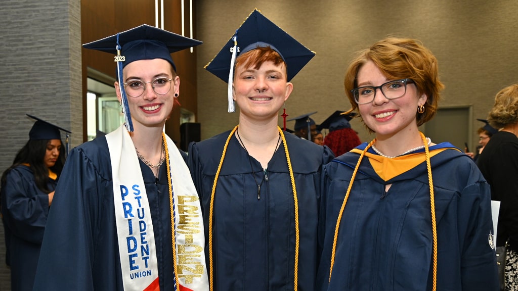 JWU Charlotte Pride Student Union President and two other grads.