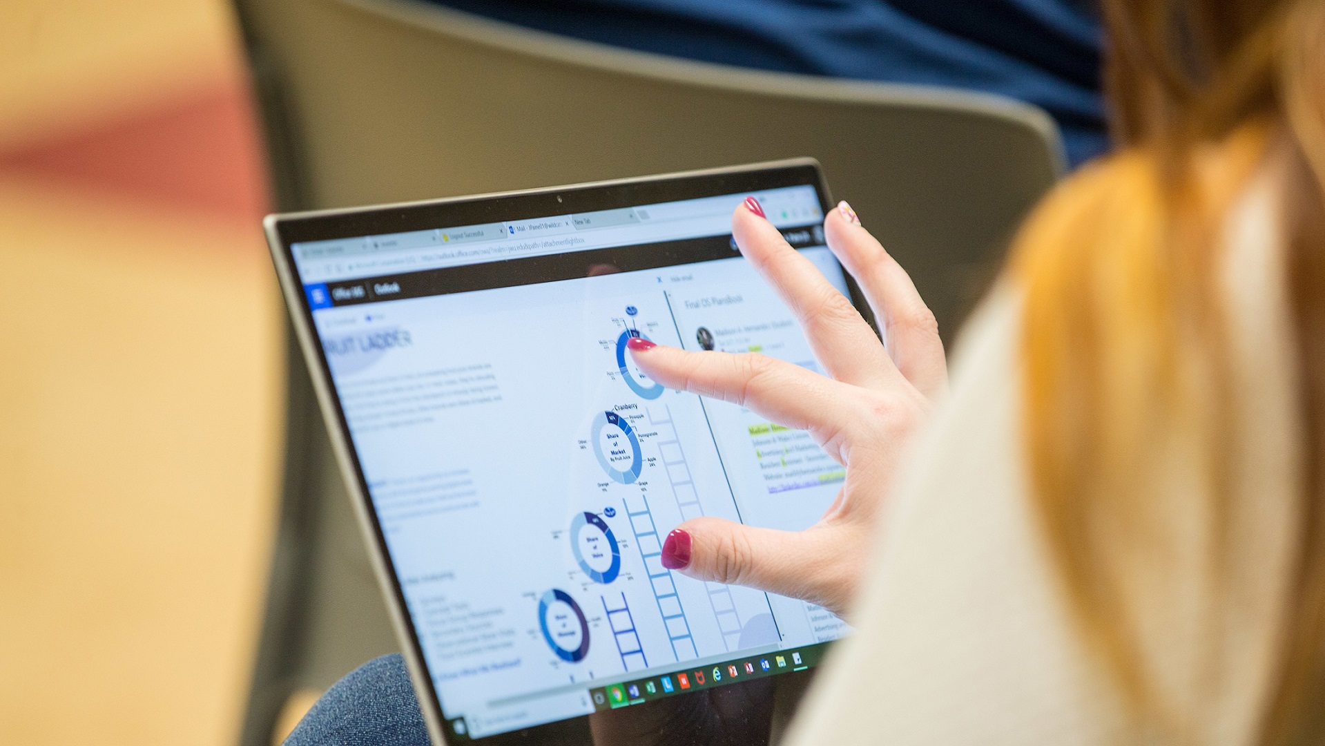 young woman viewing chart on laptop