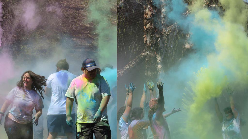 students having fun with colored chalk dust at Holi