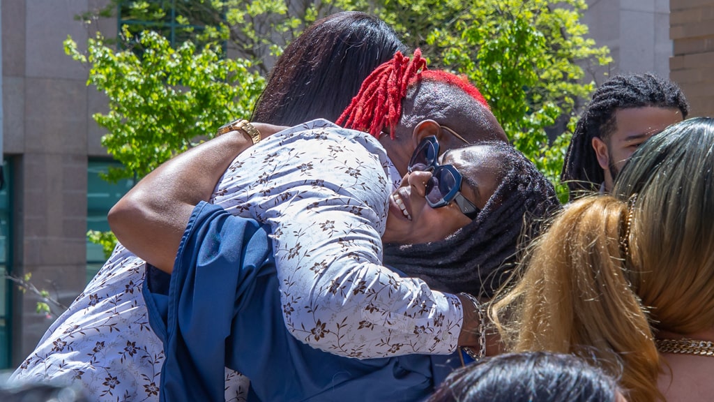 Big hug at graduate Commencement.