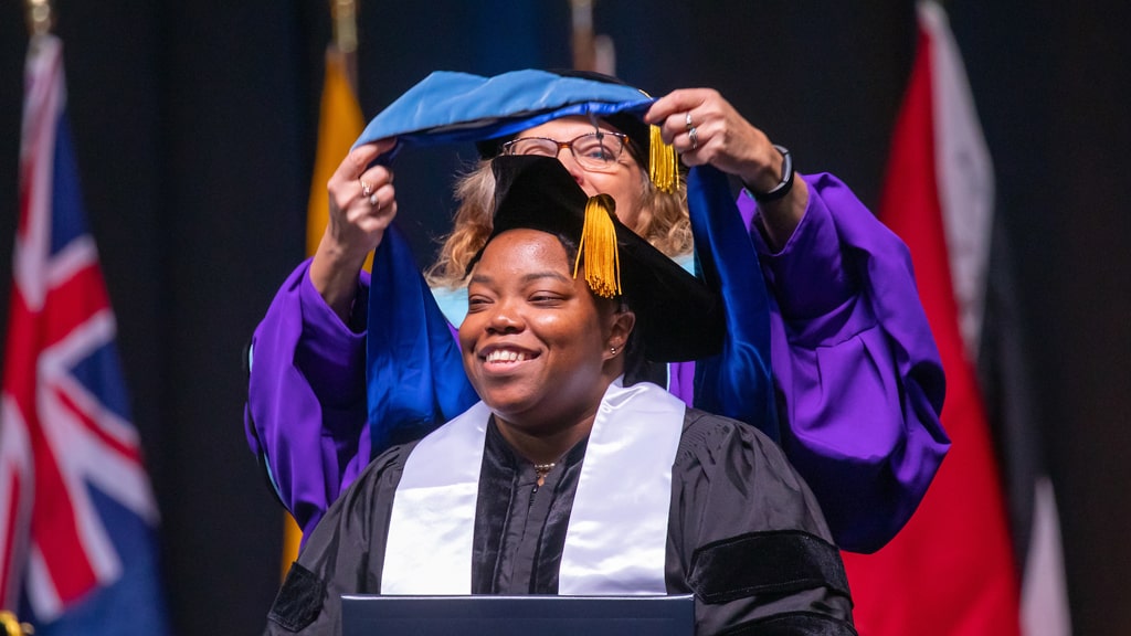 Conferring the graduate regalia at Commencement.