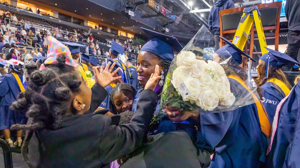 Family hug at Providence undergraduate Commencement.