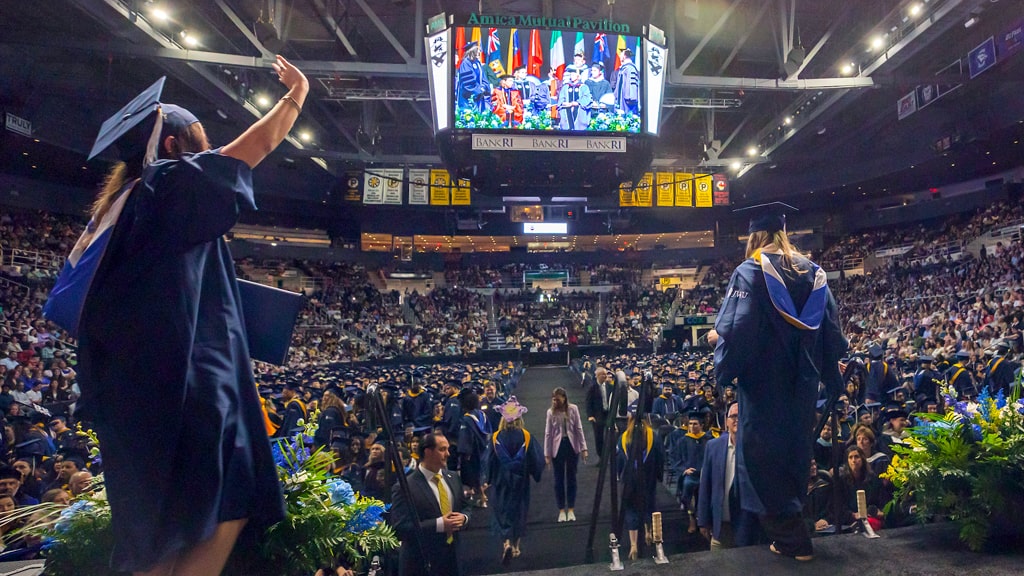 Waving to the crowd at Commencement.