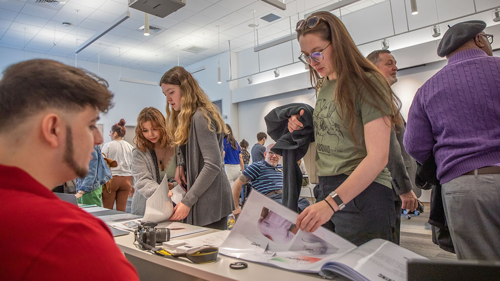 Students looking at design portfolios.