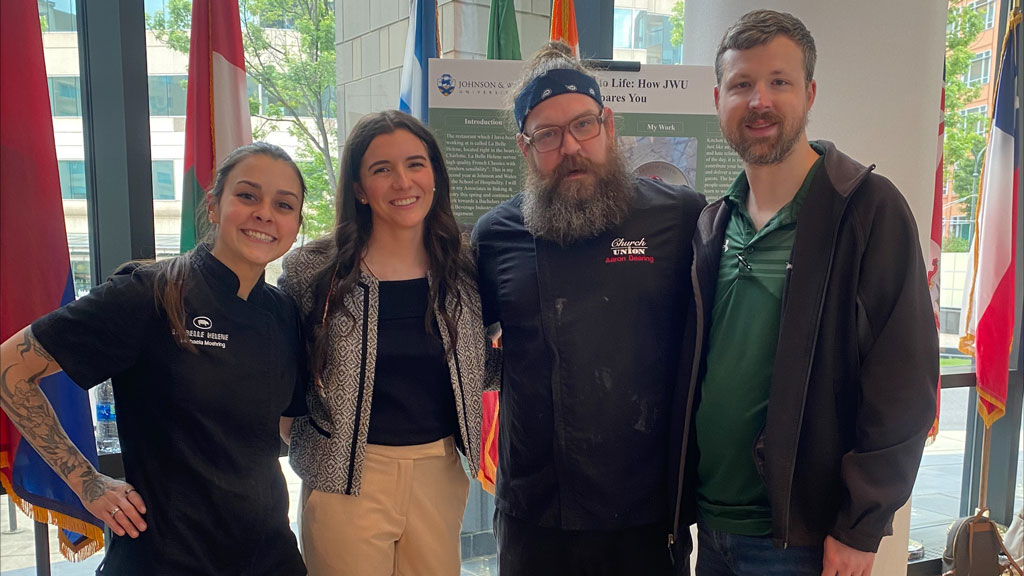 photo of four people smiling, including JWU student Isabella Gonzalez