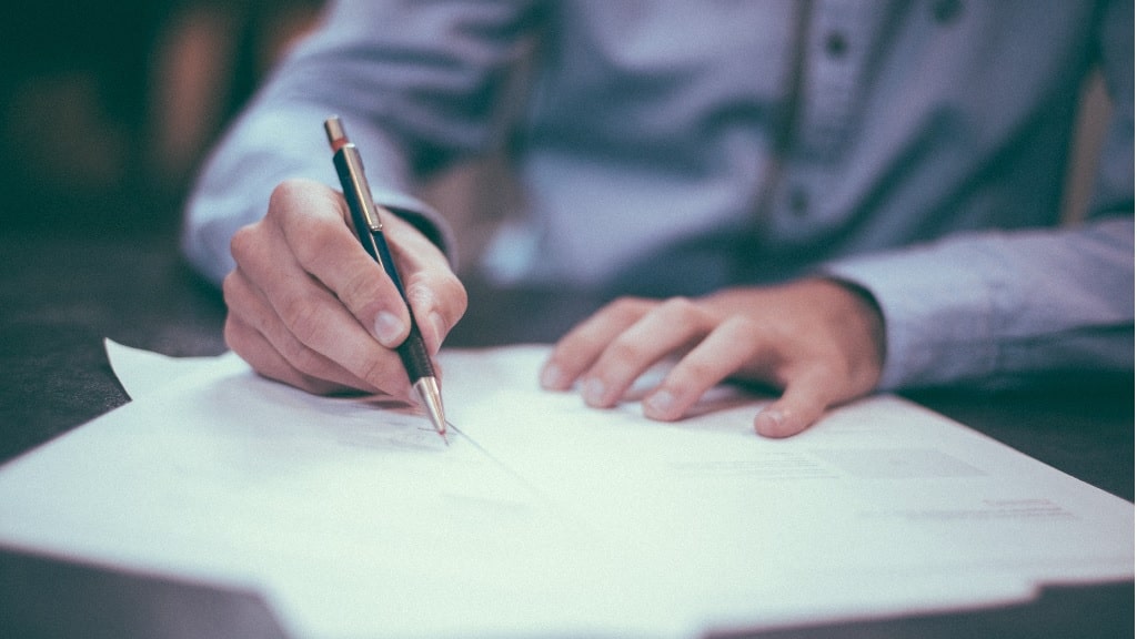 a man writing on paper