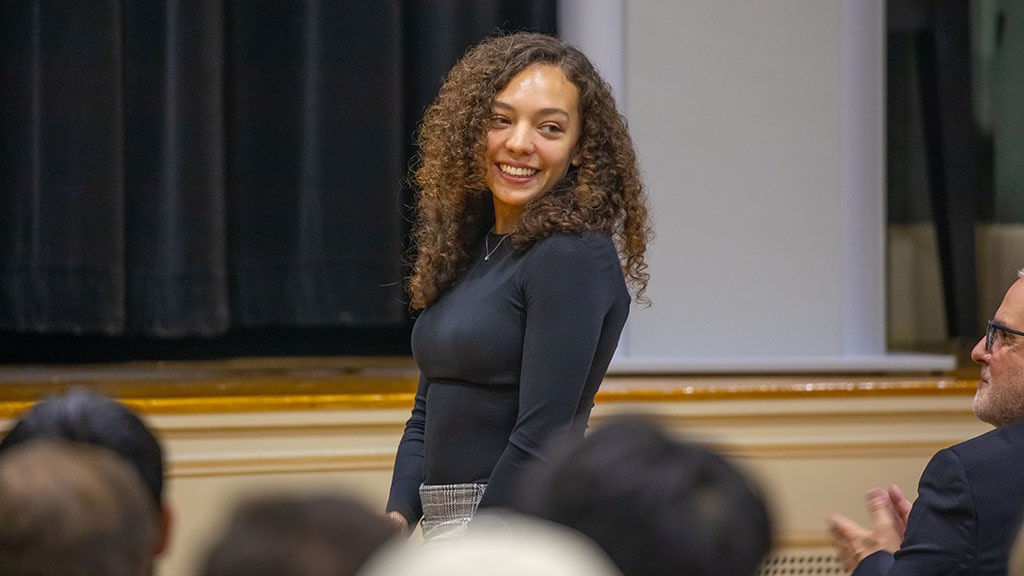 JWU junior Sofia Tamayo stands up to acknowledge applause during a VIP lecture