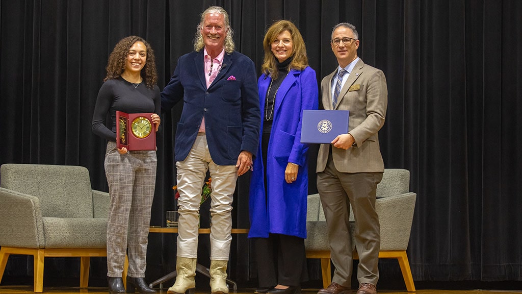 four people pause to smile for the camera on stage: Sofia Tamayo, John Hazen White, Jr., Marie Bernardo-Sousa and Michael Fein