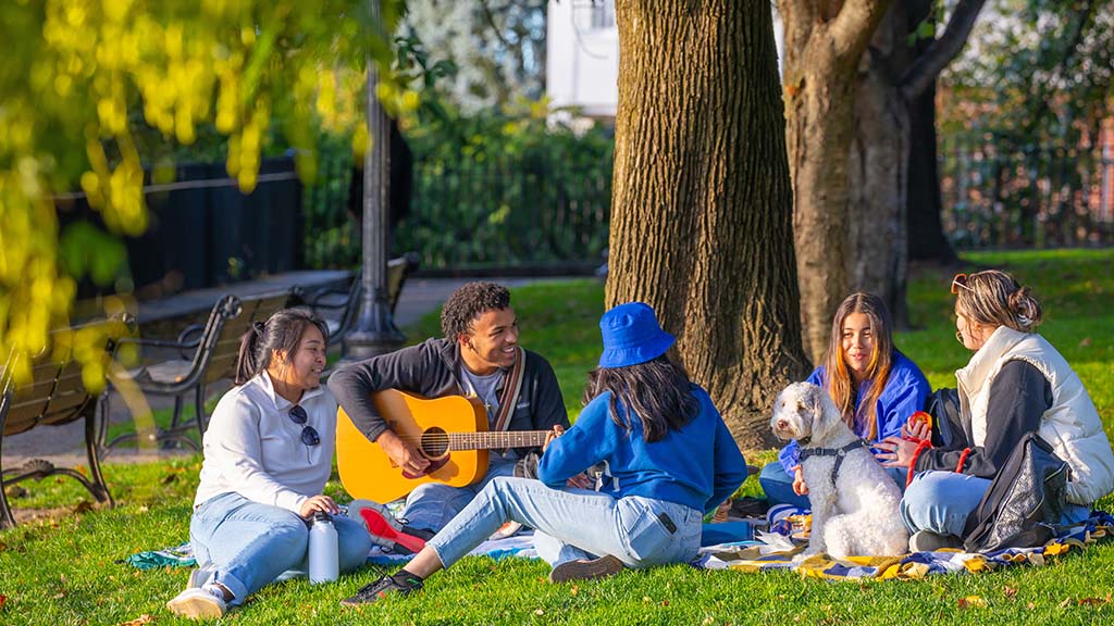 Hillary Thilavong '23, far left, enjoys a picnic with fellow JWU students at Prospect Park in Providence