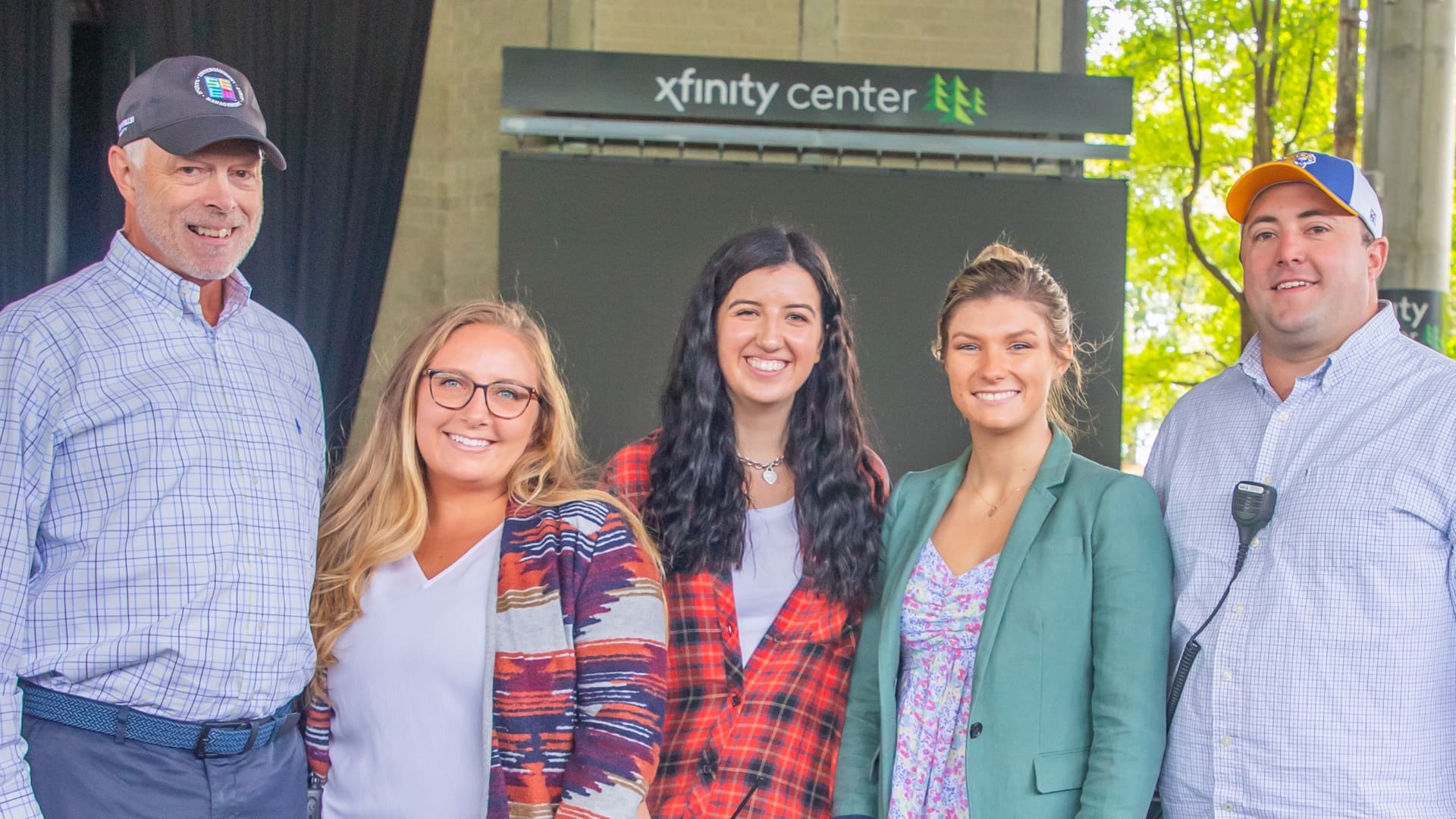 JWU SEEM Alums in a group picture at Xfinity Center