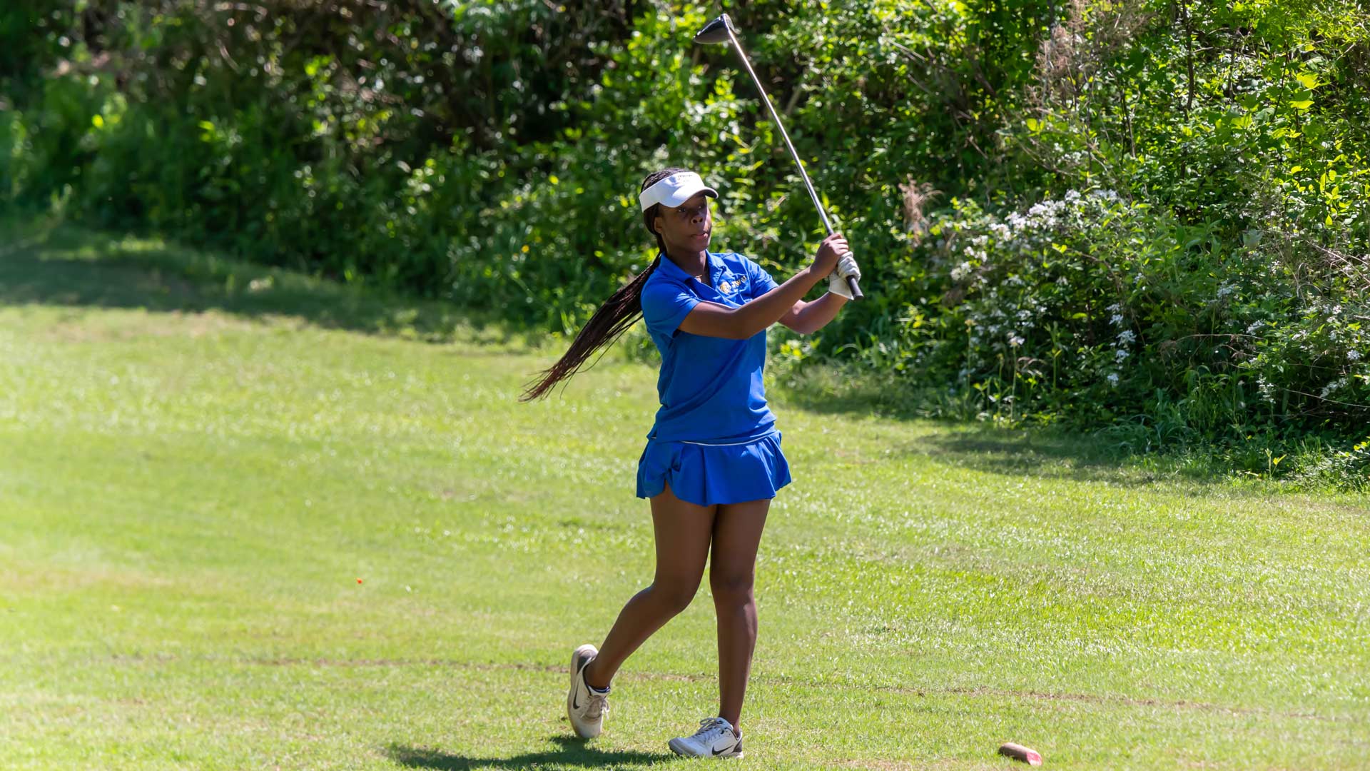 an action shot of Hopal Richards '24 playing golf